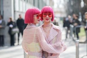 2 Beautiful Asian ladies with pink hair wearing pink glasses